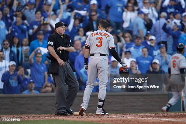 Baltimore Orioles third baseman Ryan Flaherty talks with home plate umpire Ron Kulpa after striking out looking in the 5th inning of Game 4 of the...