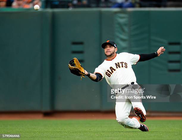 San Francisco Giants center fielder Gregor Blanco slides to catch a deep fly ball, during game 3 of the National League Conference Series between the...