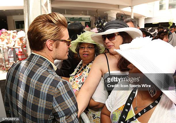 Actor Josh Henderson of the TV show Dallas interacts with fans as he arrives on the red carpet before the 140th running of the Kentucky Derby at...