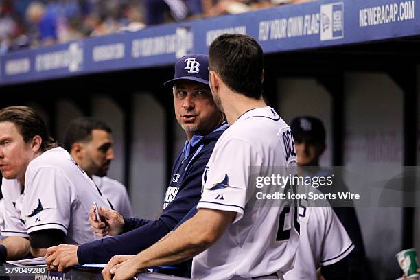 Tampa Bay Rays hitting coach Derek Shelton talks to Tampa Bay Rays left fielder Matt Joyce in the dugout during the MLB regular season game between...