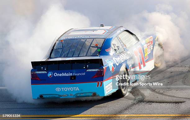 Elliott Sadler celebrates after winning the Aaron's 312 NASCAR Nationwide Series race at the Talladega Super Speedway in Talladega, AL.