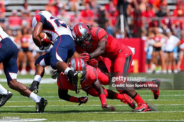 Rutgers Scarlet Knights linebacker Steve Longa and Rutgers Scarlet Knights defensive back Delon Stephenson hit Howard Bison running back Aquanius...