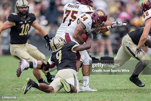 Purdue Boilermakers defensive back Anthony Brown tackles Central Michigan Chippewas running back Thomas Rawls during a football game between the...