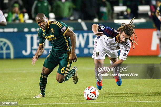 Portland Timbers forward/midfielder Darlington Nagbe battles with a falling Real Salt Lake midfielder Kyle Beckerman for the ball during the game...