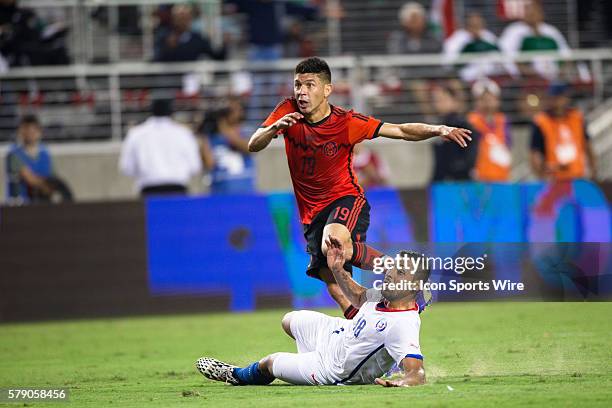 Mexico forward Oribe Peralta tries a shot on goal but is blocked by Chile defender Gonzalo Jara , during the game between Mexico and Chile at Levi's...