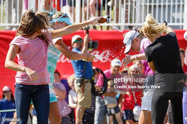 Natalie Gulbis and Lexi Thompson run out to the 18th green to celebrate Stacy Lewis' win after the final round of the North Texas LPGA Shootout...