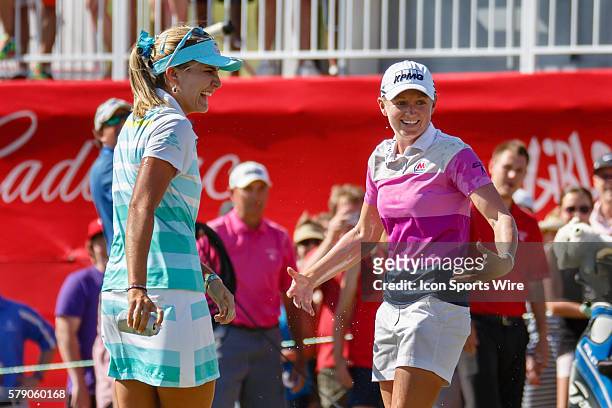 Lexi Thompson shares a laugh with Stacy Lewis after Stacy is doused with beer after the final round of the North Texas LPGA Shootout played at the...