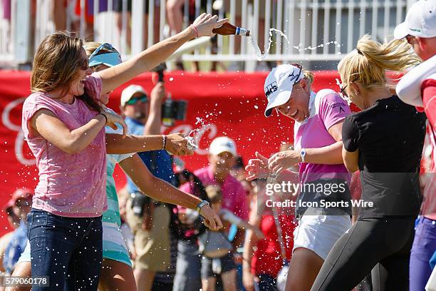 Natalie Gulbis and Lexi Thompson run out to the 18th green to celebrate Stacy Lewis' win after the final round of the North Texas LPGA Shootout...