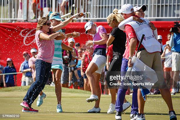 Natalie Gulbis, Lexi Thompson and Alison Walshe run out to the 18th green to celebrate Stacy Lewis' win after the final round of the North Texas LPGA...