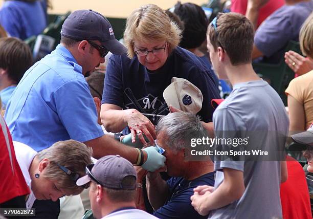 Fan suffers an injury after getting hit by a foul ball during game action. The Brewers host the Cardinals at Miller Park in Milwaukee, WI.