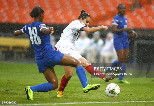 Carolina Venegas of Costa Rica fires a shot past Aurelie Rouge of Martinique during a CONCACAF Women's World Cup qualifier at RFK Stadium, in...