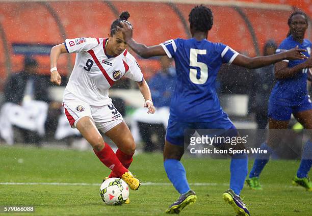 Carolina Venegas of Costa Rica cuts past Johanne Guillou of Martinique during a CONCACAF Women's World Cup qualifier at RFK Stadium, in Washington...