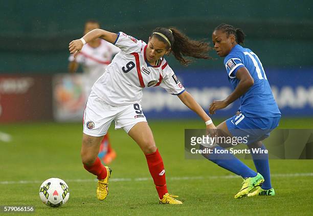 Carolina Venegas of Costa Rica moves past Sylvia Solbiac of Martinique during a CONCACAF Women's World Cup qualifier at RFK Stadium, in Washington...