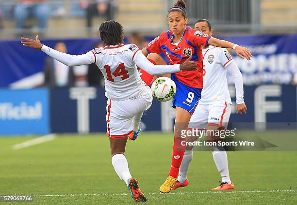 Carolina Venegas of Costa Rica goes for the ball against Karyn Forbes of Trinidad & Tobago during a CONCACAF Women's World Cup semi-final qualifier...
