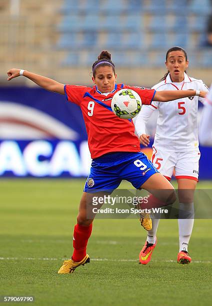 Carolina Venegas of Costa Rica pulls the ball down in front of Arin King of Trinidad & Tobago during a CONCACAF Women's World Cup semi-final...