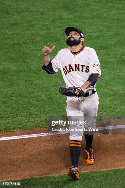 San Francisco Giants relief pitcher Sergio Romo points skyward at the end of the inning, during game three of the World Series between the San...