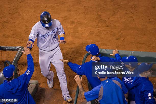 Kansas City Royals left fielder Alex Gordon celebrates scoring in the dugout, in the 6th inning during game three of the World Series between the San...