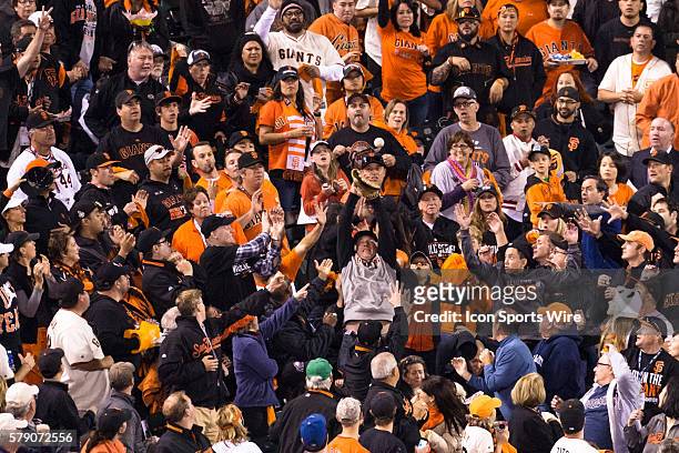 Fans prepares to catch a foul fly ball, during game three of the World Series between the San Francisco Giants and the Kansas City Royals at AT&T...