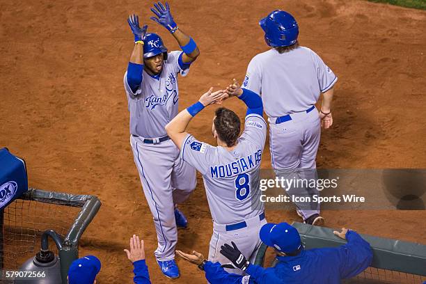 Kansas City Royals shortstop Alcides Escobar celebrates scoring on a two-run double by Gordon , with Kansas City Royals third baseman Mike Moustakas...