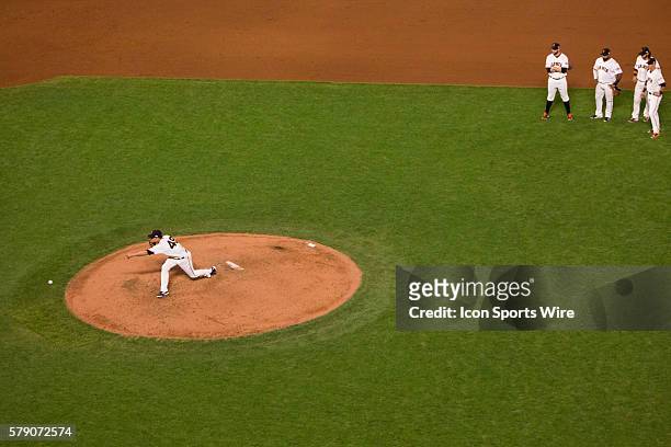 San Francisco Giants relief pitcher Javier Lopez warms up on the pitcher's mound in the 6ht inning, as San Francisco Giants first baseman Brandon...