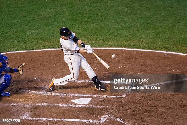 San Francisco Giants catcher Buster Posey at bat and connecting with the ball in the 4th inning, during game three of the World Series between the...