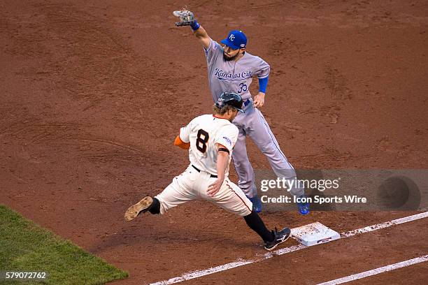 San Francisco Giants right fielder Hunter Pence is thrown out at first base after Kansas City Royals first baseman Eric Hosmer makes the catch,...