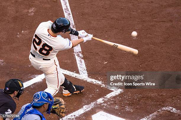 San Francisco Giants catcher Buster Posey at bat and connecting with the ball, during game three of the World Series between the San Francisco Giants...