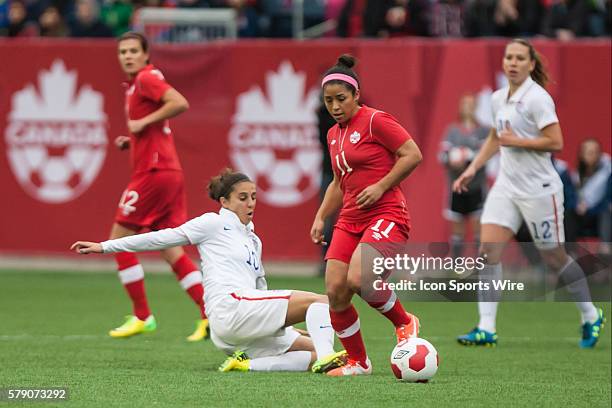 May 2014 Team USA's Carli Lloyd tries to tackle Team Canada's Desiree Scott during the USA v Canada game at the Investors Group Field in Winnipeg MB.