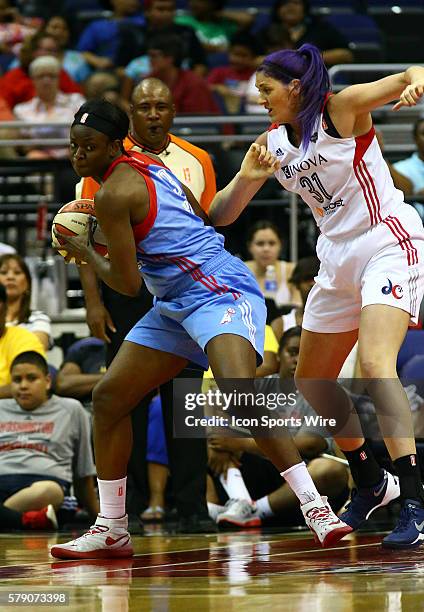 Aneika Henry of the Atlanta Dream holds the ball away from Stefanie Dolson of the Washington Mystics during a WNBA game at Verizon Center, in...