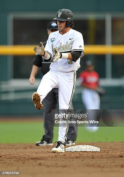 Vanderbilt's Dansby Swanson celebrates after hitting a double during the College World Series game between the Vanderbilt Commodores and the...