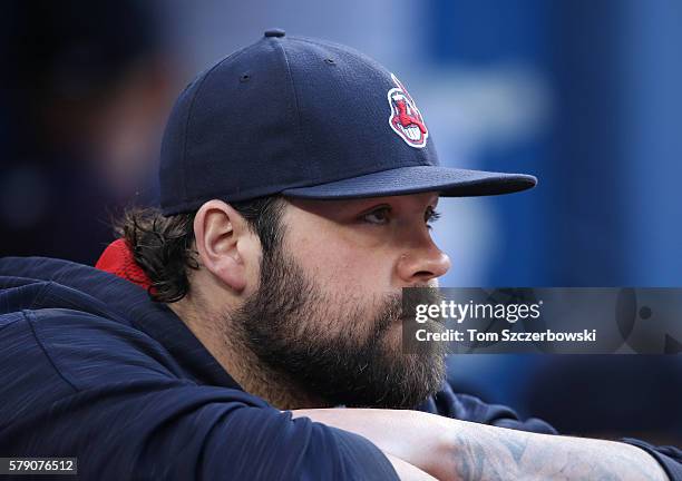 Joba Chamberlain of the Cleveland Indians looks on from the top step of the dugout during MLB game action against the Toronto Blue Jays on June 30,...