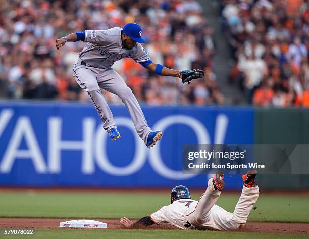 Kansas City Royals shortstop Alcides Escobar jumps to catch a throw as San Francisco Giants center fielder Gregor Blanco steals second base, in the...
