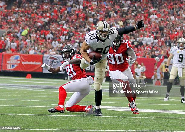 New Orleans Saints tight end Jimmy Graham looks for extra yardage over Atlanta Falcons cornerback Desmond Trufant and defensive end Stansly Maponga...