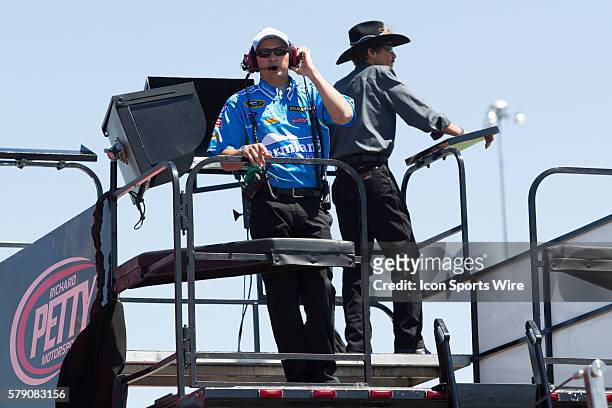 Trent Owens, crew chief for Aric Almirola, driver of the Farmland Ford watches practice from atop the hauler with The King, Richard Petty looking...