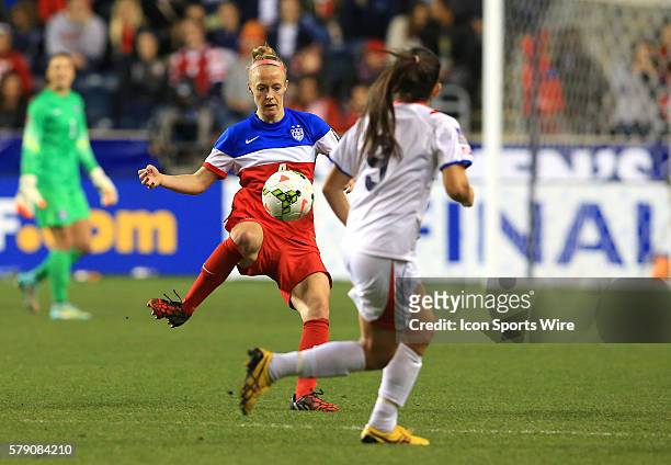 Becky Sauerbrunn of the USA controls the ball as Carolina Venegas of Costa Rica watches during the championship match of the CONCACAF Women's World...