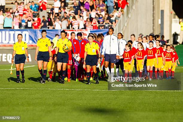 The referees bring out the game ball with a contingency of youth soccer clubs prior the the start of a women's soccer match between the United States...
