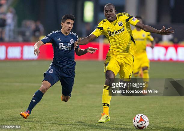 Tony Tchani of the Columbus Crew and Sebasti??n Fern??ndez of the Vancouver Whitecaps FC battle for the ball during the game between the Vancouver...