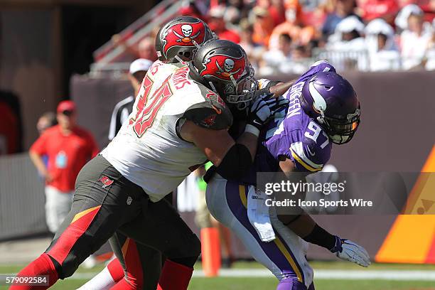 Minnesota Vikings defensive end Everson Griffen is blocked by Tampa Bay Buccaneers guard Logan Mankins and Tampa Bay Buccaneers tackle Anthony...