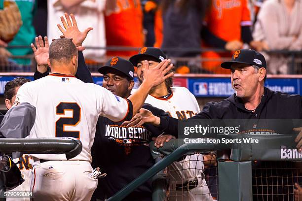 San Francisco Giants left fielder Juan Perez celebrates scoring in the 8th inning as he heads in to the dugout during game 5 of the World Series...