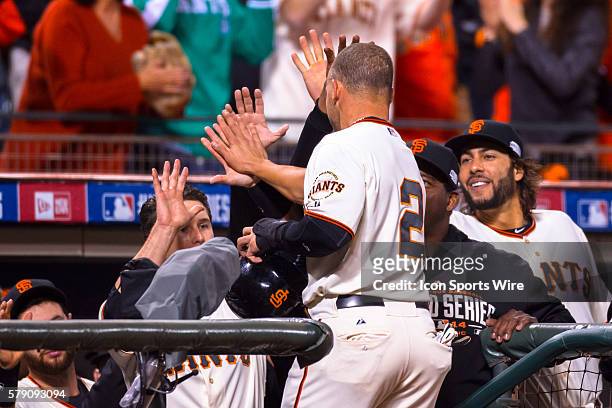 San Francisco Giants left fielder Juan Perez celebrates scoring in the 8th inning as he heads in to the dugout during game 5 of the World Series...