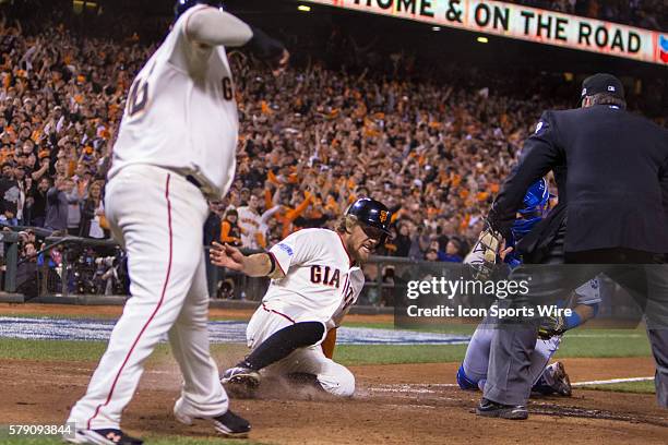 San Francisco Giants right fielder Hunter Pence slides home behind San Francisco Giants third baseman Pablo Sandoval on a two-run double by San...