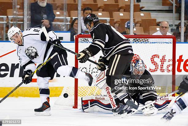 Hershey Bears' Mike Moore makes sure Manchester Monarch's Sean Backman doesn't have a shot at the loose puck in front of Hershey Bears' Philipp...