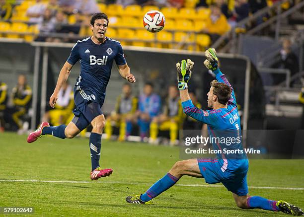 Omar Salgado of the Vancouver Whitecaps FC chipping the ball over Steve Clark of the Columbus Crew during the game between the Vancouver Whitecaps FC...