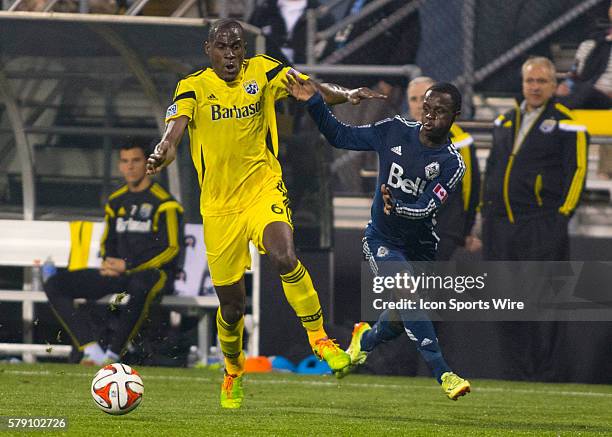 Tony Tchani of the Columbus Crew and Kekuta Manneh of the Vancouver Whitecaps FC battle for the ball during the game between the Vancouver Whitecaps...