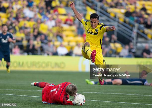 Jairo Arrieta of the Columbus Crew jumping over David Ousted of the Vancouver Whitecaps FC during the game between the Vancouver Whitecaps FC and the...