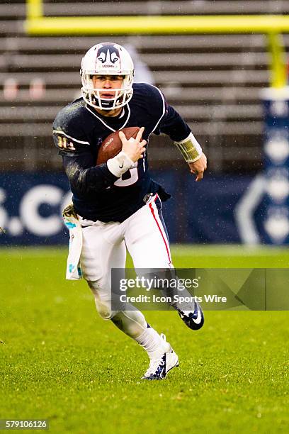 Uconn Huskies Quarterback Chandler Whitmer runs down field during an American Athletic Conference football game between the University of Central...