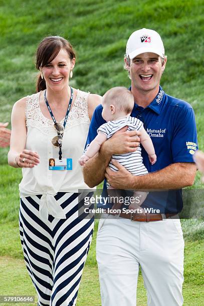 Kevin Streelman makes his way down to accept the trophy with with Courtney and daughter Sophie after winning the Travelers Championship at TPC River...