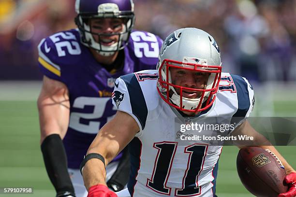 New England Patriots wide receiver Julian Edelman carries the ball and is forced out of bounds by Minnesota Vikings free safety Harrison Smith . The...