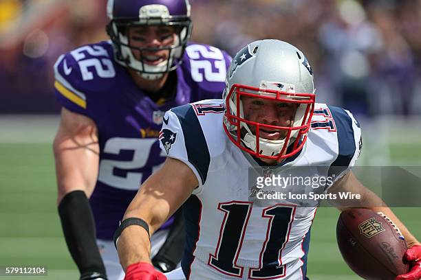 New England Patriots wide receiver Julian Edelman carries the ball and is forced out of bounds by Minnesota Vikings free safety Harrison Smith . The...