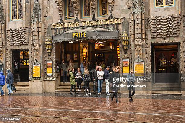 theater tuschinski in amsterdam - couple entering the theater stock pictures, royalty-free photos & images